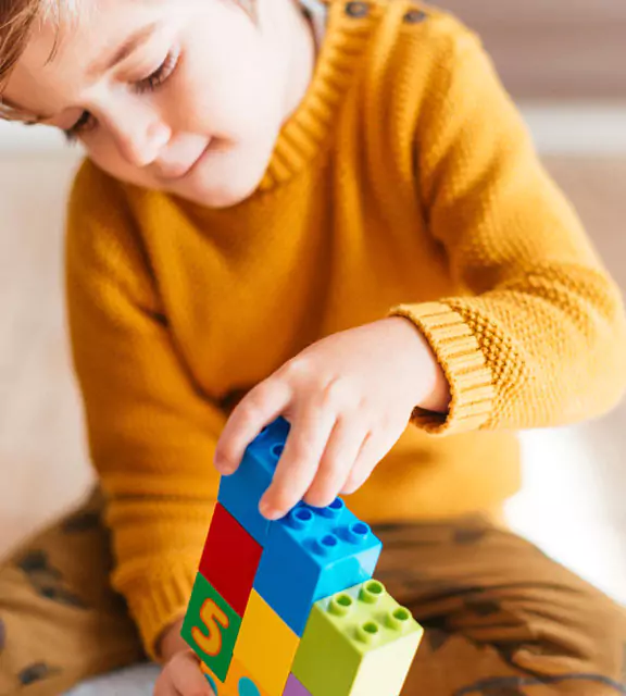 image of child playing with building blocks